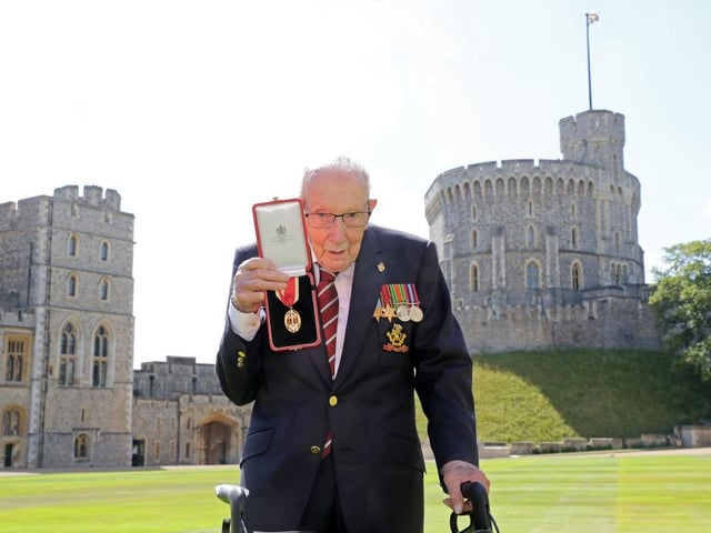 Sir Tom Moore poses with his medal after being made a Knight Bachelor during an investiture at Windsor Castle. (Photo by Chris Jackson / POOL / AFP)