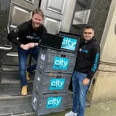 Arnie and a colleague pictured with City Taxis' laptop donation outside Cutlers' Hall, one of the drop off points.