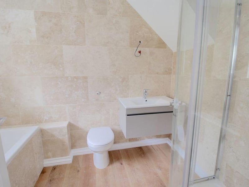 This attractively decorated four-piece en suite is attached to the master bedroom. It comprises bath, separate shower cubicle, wash hand basin and WC.