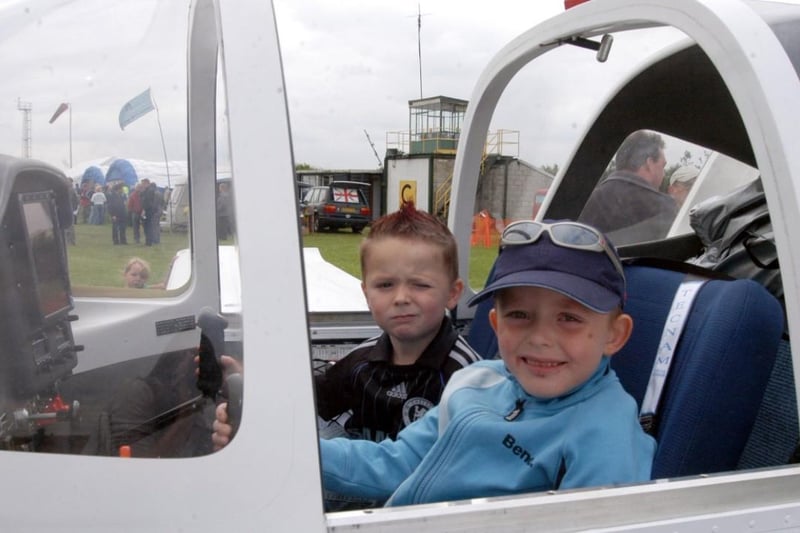 Two young flying aces test out a plane at the Hucknall Air Show on the aerodrome