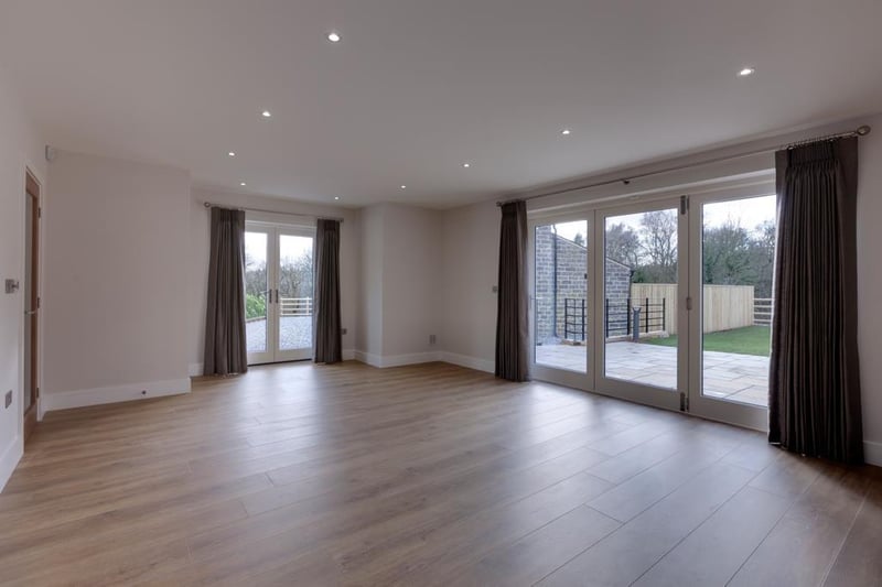 A spacious reception room with recessed lighting, feature lighting, fitted storage cupboards, TV/aerial point, data point and engineered timber flooring with under-floor heating. Double doors open to the front of the property and bi-fold doors open to the side of the property.