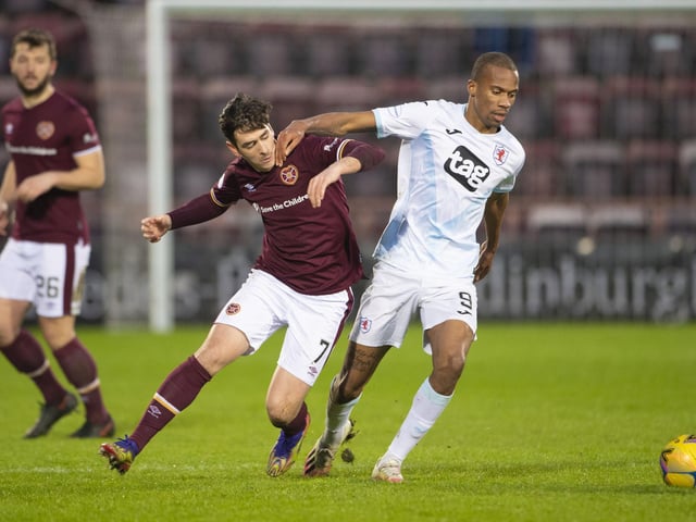 Hearts' Jamie Walker tussles with Manny Duku.