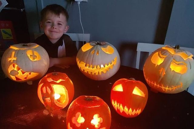 This youngster looks impressed with the many different carvings on these pumpkins. Image: Kyle Benson