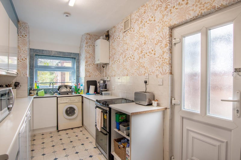 The fitted kitchen has a garden view and access to the side drive.