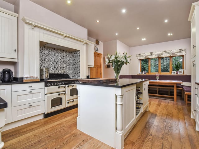 The kitchen has an island and a breakfast area.