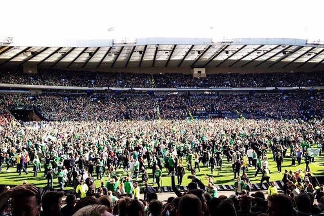 Hibs fans stream onto the pitch at the full time whistle