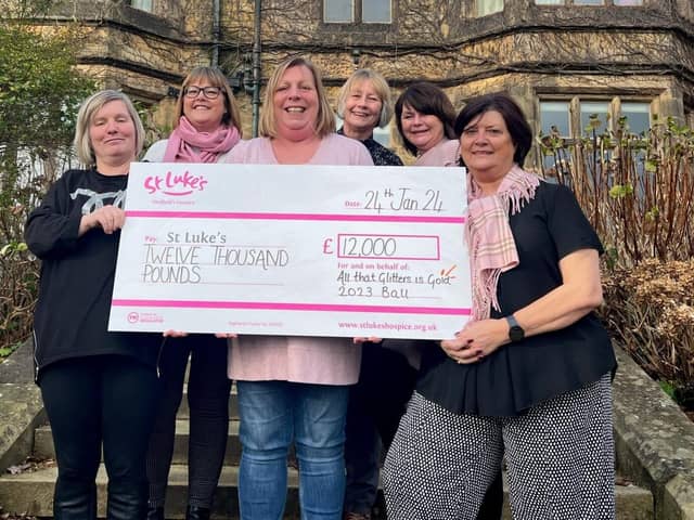 Karen and her fundraising team present their latest cheque to St Luke's
