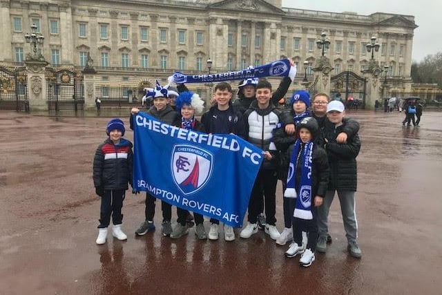 These fans pose for a picture outside Buckingham Palace before heading to the game.