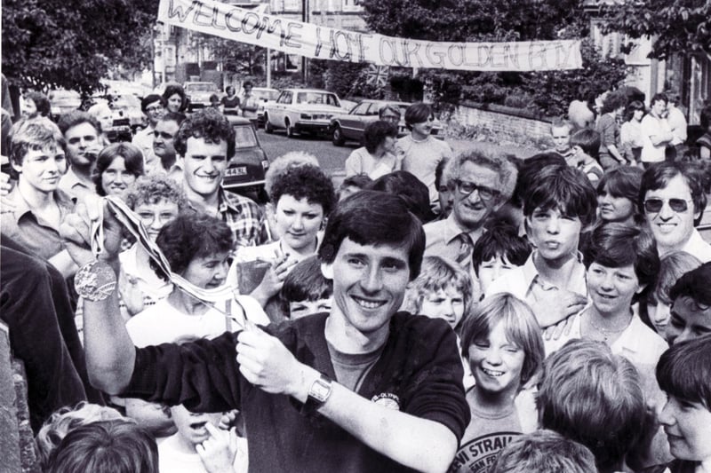 Sebastian Coe is mobbed by fans and neighbours as he displays his Olympic gold medal outside his home in Sheffield on August 3, 1980