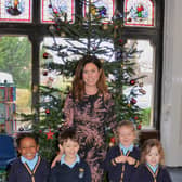 Mylnhurst School is celebrating after being named among the Top 100 preparatory schools in the country by The Sunday Times. Pictured are headmistress Hannah Cunningham with some of the nursery children.