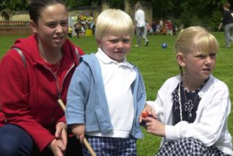 Children enjoying the garden party at Hickelton Hall in 2000. Siblings Victoria, Mitchell and Rebecca Adlard at a hook a duck game.