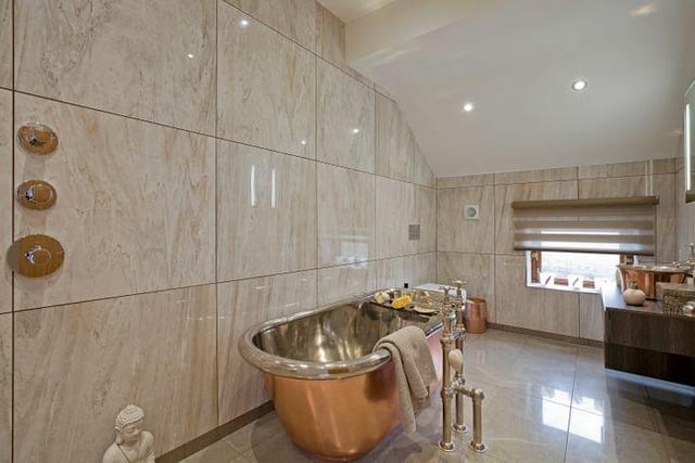 The house features a newly installed luxury en suite bathroom with a copper statement freestanding roll top bath