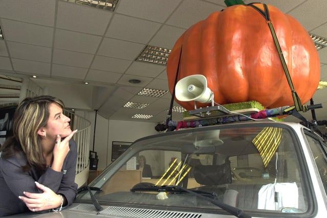 Adele Gregory a 'Smart' car Sales Rep at the Mercedes-Benz showroom on Hanover way looking at a car in the showroom with a pumpkin on its roof in 2003
