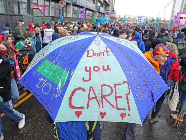 Climate Justice Activists at the Cop26 Gates asking delegates as they make final decisions, "Are You With Us Or With Fossil Fuels?" during the official final day of the Cop26 summit in Glasgow. Picture date: Friday November 12, 2021.