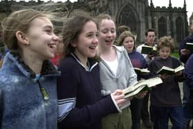 Cathedral choir members sing outside Sheffield Cathedral. Picture: JPIMedia.