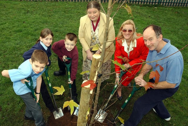 Kingfisher Primary School pupils, from left, Luke Stuchbury, aged nine, Victoria Powell, aged ten, and  Luke Soffe, aged nine, along with deputy chair of Doncaster Council, Councillor Susan Bolton, vice-chair of school governors, Councillor Eva Hughes, and teacher Dave Martin, planted a tree in the school grounds in 2004