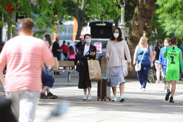 Shoppers wear face masks as they return to Commercial Road in Portsmouth as stores reopen. Picture: Sarah Standing (150620-4150)