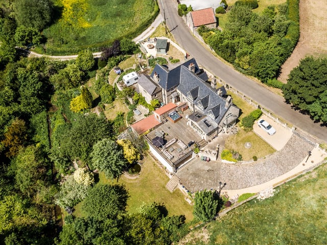 Externally the property provides a large elevated terrace, landscaped gardens with meandering stream and ample gated off street parking with garage.