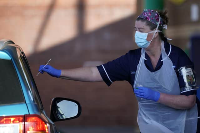 Nurses instruct and help NHS workers as they self swab for coronavirus at a drive through testing site in Sheffield.