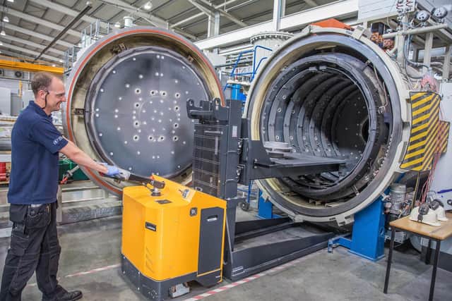 David Loomes, Technical Manager, loading a Class A Pump Impeller into a Vacuum Heat Treatment Furnace at CTI.