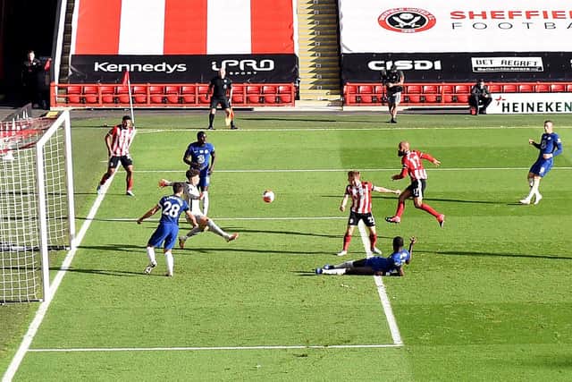 Sheffield United's David McGoldrick scores his side's third goal of the game during the Premier League match at  Bramall Lane, Sheffield: Shaun Botterill/NMC Pool/PA Wire.
