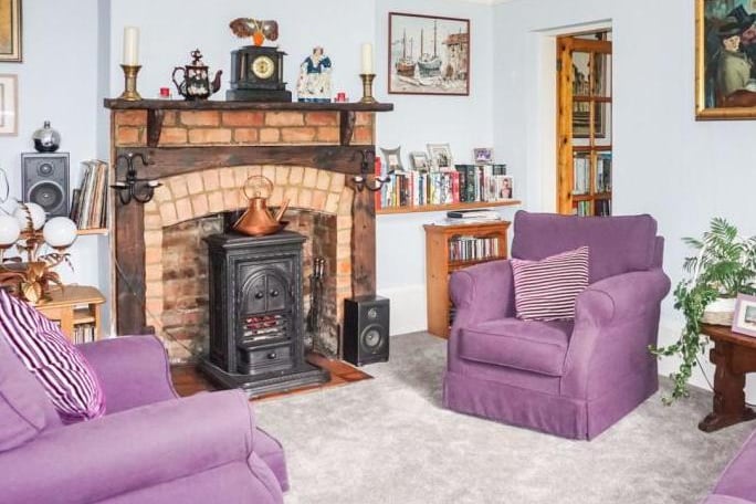 Further sitting room with brick feature fire place and wood burner stove