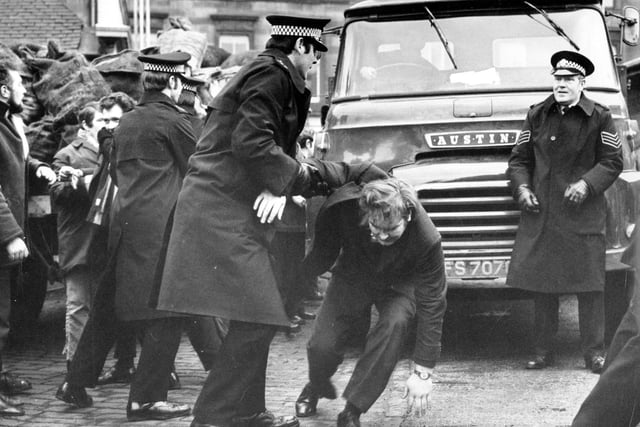 Police move in when pickets mob the driver of a lorry collecting coal from the Haymarket coal depot in Edinburgh.