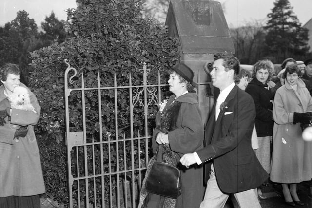 Actor Dirk Bogarde arrives for his brother's wedding at Colinton in December 1956.