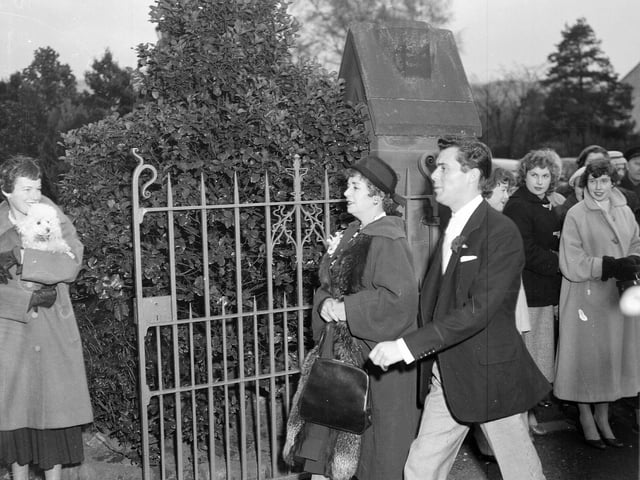 Actor Dirk Bogarde arrives for his brother's wedding at Colinton in December 1956.