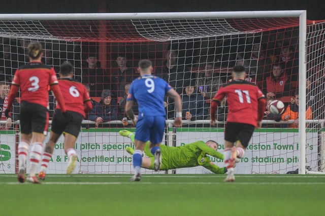 Ross Durrant gets down to save Harry Vince's penalty.