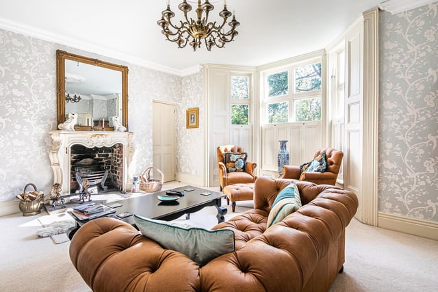 The large fireplace and bay window are key selling points in the sitting room.