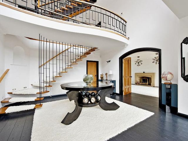 The ground floor of the property is approached through an impressive glazed entrance and reception hall, with a central galleried landing and ash flooring.