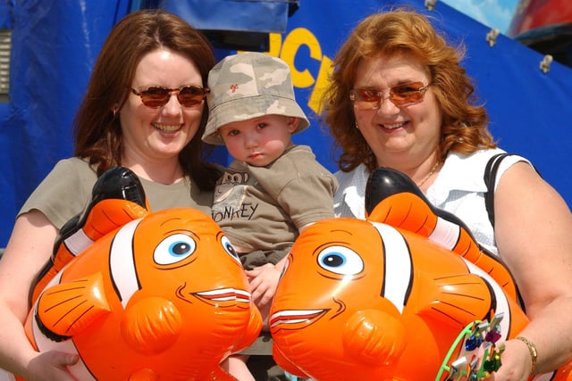 Tracey Aitchinson, Archie Aitchinson, aged 17 months and Janet Aitchinson with their prizes from the hook a ball stall back in 2004