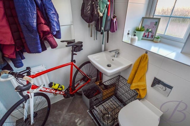 Doubling up as a cloakroom at the moment (and indeed a bike garage!) is the downstairs toilet. Complete with full-height tiling, it has a wall-hung wash basin, a low-flush WC, central-heating radiator and opaque window.