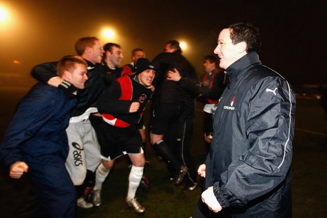 Paul Cox celebrates with the players.