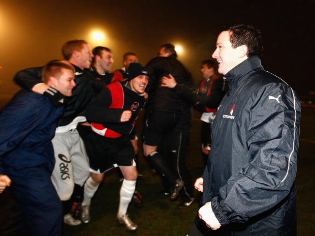 Paul Cox celebrates with the players.