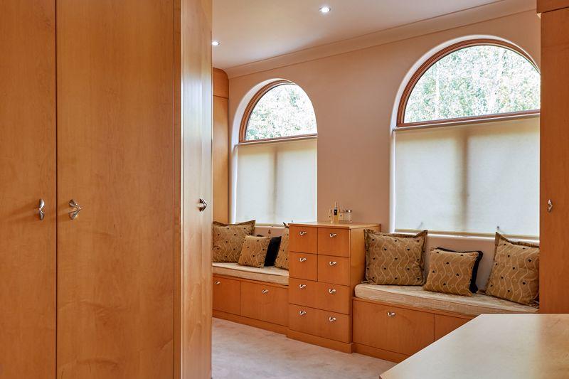 The master dressing room has a large dressing area and two soft window seats as a perfect place to start your day.