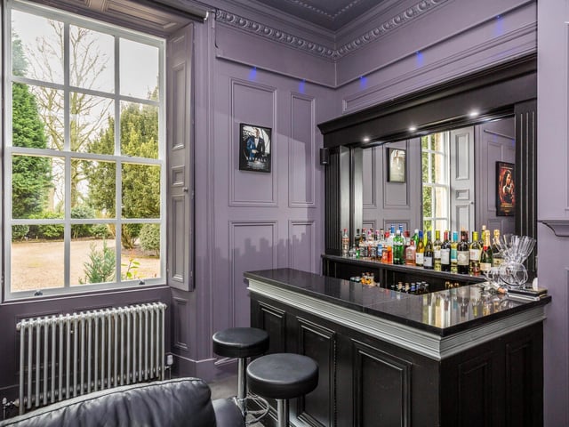 Built in bar area with shelving storage and granite surfaces.