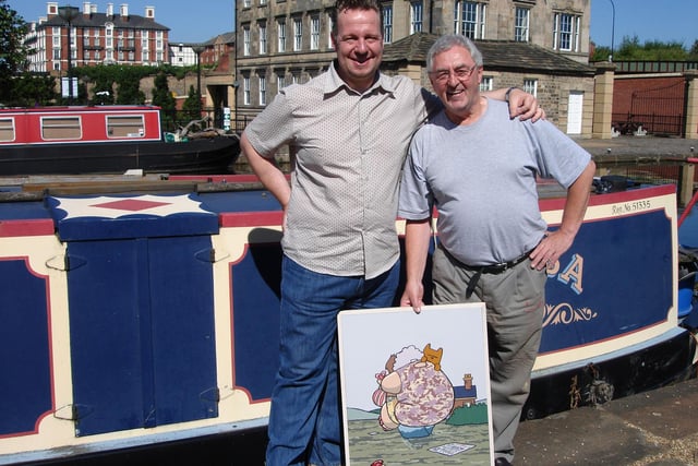 Pete McKee visiting fellow Sheffield artist Joe Scarborough at his floating studio in Victoria Quays - Joe is holding a picture that Pete painted to help raise money for the victims of the Sheffield floods in June 2007