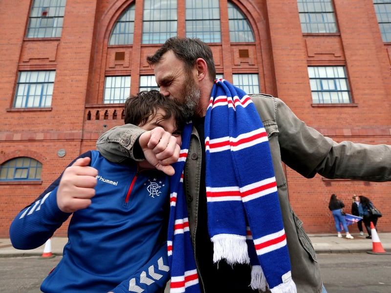 Rangers fans celebrate outside of the Ibrox Stadium after Rangers win the Scottish Premiership title.
