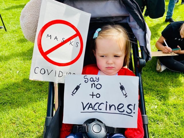 An unamused protester taking part in the anti-mask protest where hundreds have gathered to demonstrate against restrictions brought in since the pandemic hit the UK.