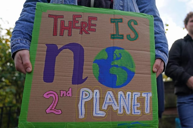 Demonstrators at Kelvingrove Park, with a placard reading: "There is no second planet"