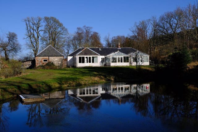 A two-bedroom cottage with two conservatories overlooks the lochan.