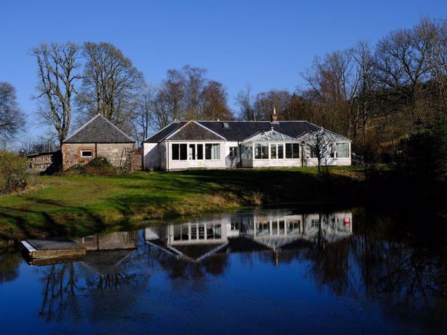 A two-bedroom cottage with two conservatories overlooks the lochan.