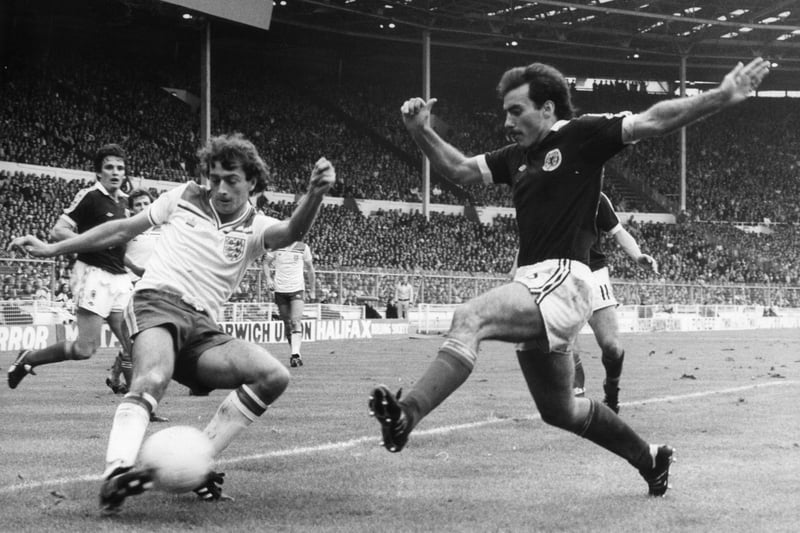 England's Trevor Francis traps the ball as Willie Miller comes in to tackle from the right