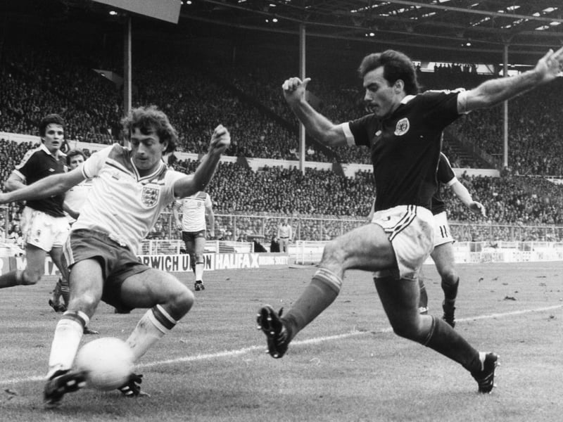 England's Trevor Francis traps the ball as Willie Miller comes in to tackle from the right