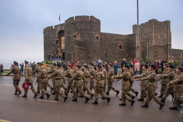 The Remembrance Sunday parade passes Carrickfergus Castle.