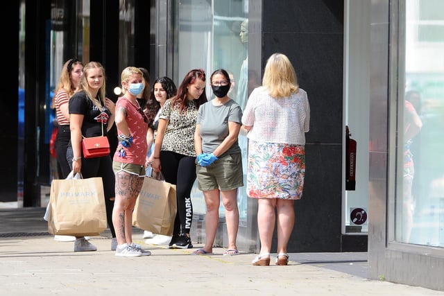 Shoppers queuing in Commercial Road in Portsmouth after stores reopened for business. Picture: Sarah Standing (150620-4143)