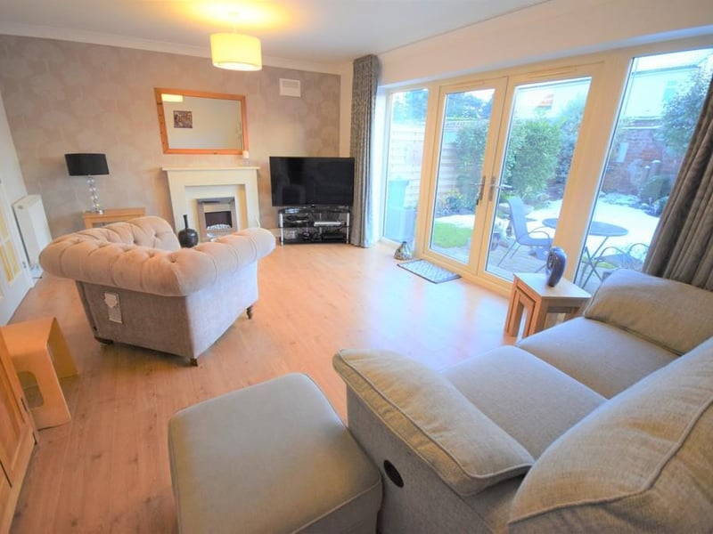A spacious and stylishly decorated living room having beautiful UPVC French doors which open out to the patio and gardens