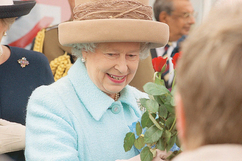 Her Majesty looks delighted to receive a wonderful bouquet during her visit.